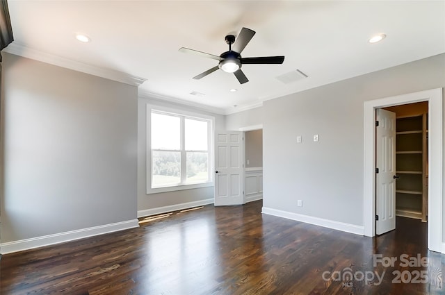 empty room with ceiling fan, dark hardwood / wood-style flooring, and crown molding