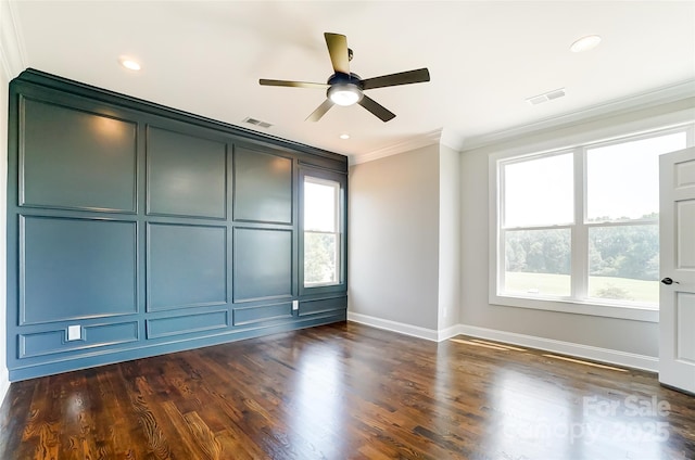 empty room featuring crown molding, ceiling fan, and dark wood-type flooring