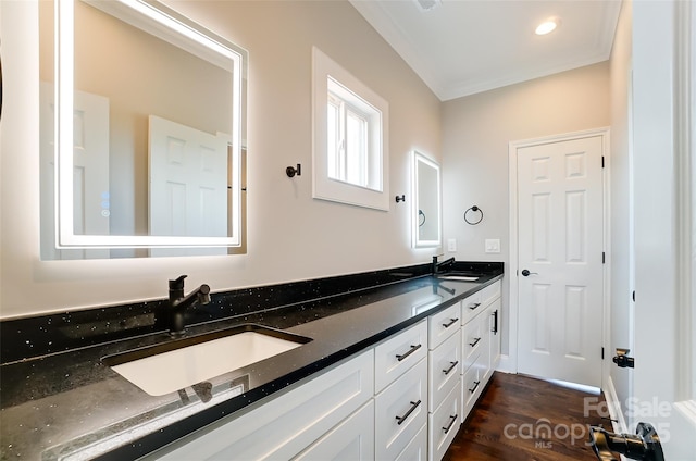 bathroom featuring vanity, wood-type flooring, and crown molding