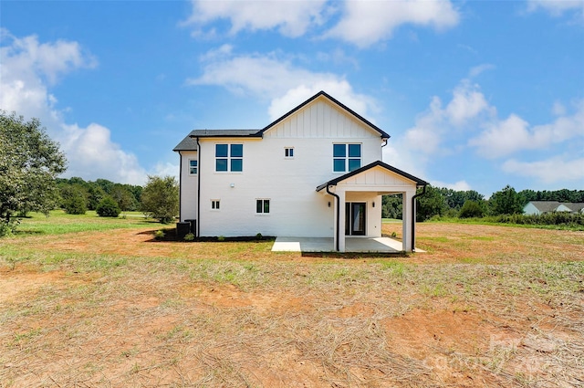 back of property featuring a patio area and a lawn