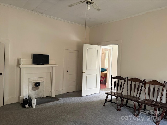 living area featuring ceiling fan, ornamental molding, and dark carpet