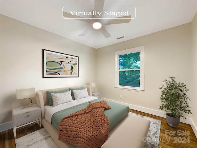 bedroom with ceiling fan and hardwood / wood-style flooring