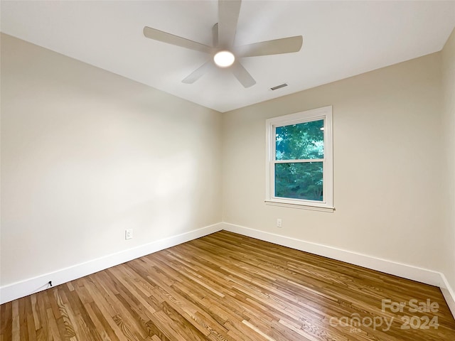 empty room with light wood-type flooring and ceiling fan