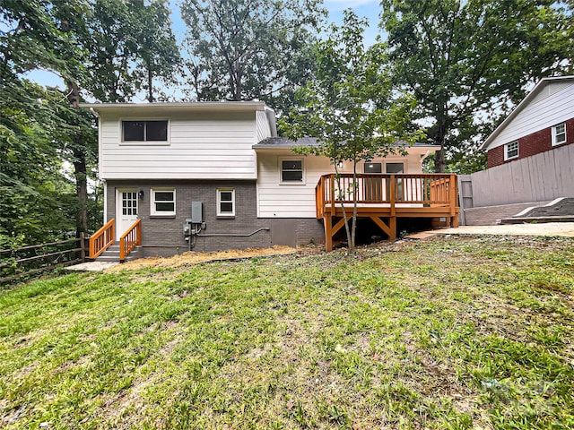 back of house with a wooden deck and a yard