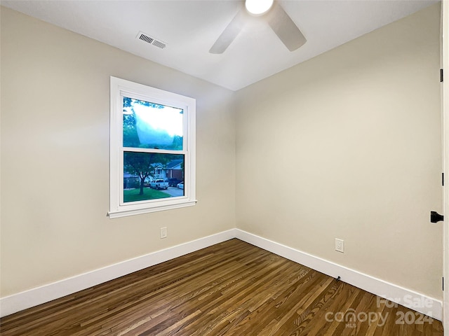 spare room featuring ceiling fan and dark wood-type flooring