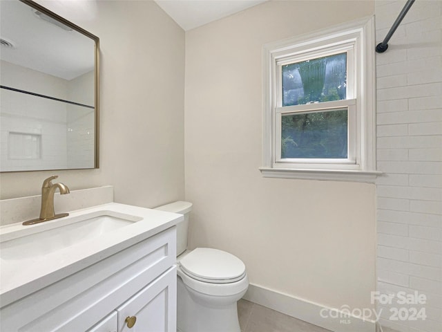 bathroom featuring vanity, toilet, and tile patterned flooring