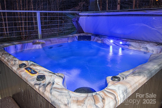 view of swimming pool featuring a hot tub