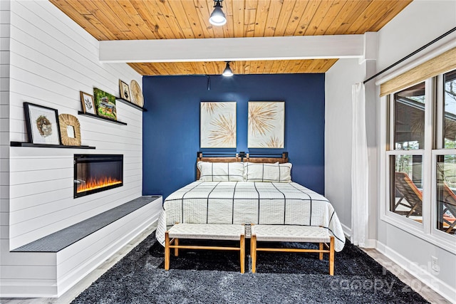 bedroom featuring beamed ceiling, wooden ceiling, and wooden walls