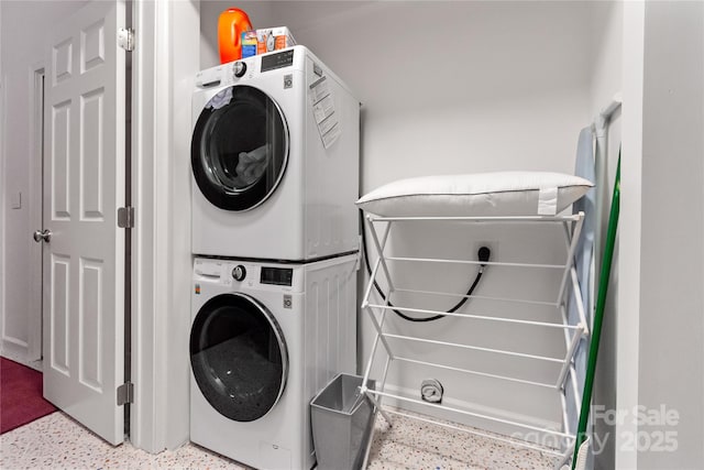 washroom with stacked washer and clothes dryer