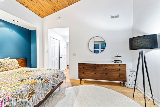 bedroom featuring lofted ceiling, light wood-type flooring, and wood ceiling