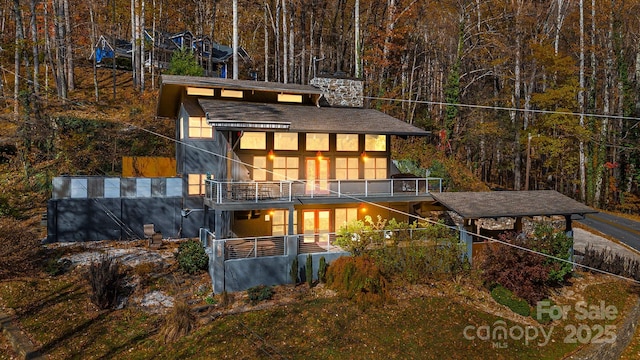 rear view of property with a balcony