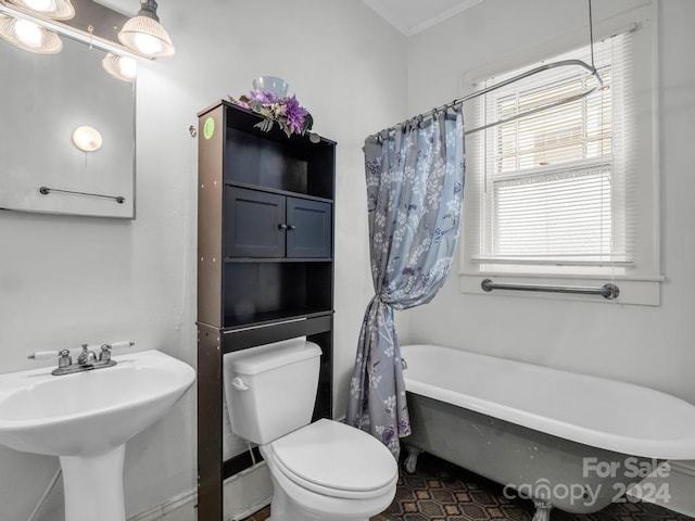 bathroom featuring crown molding, tile patterned floors, a bath, and toilet