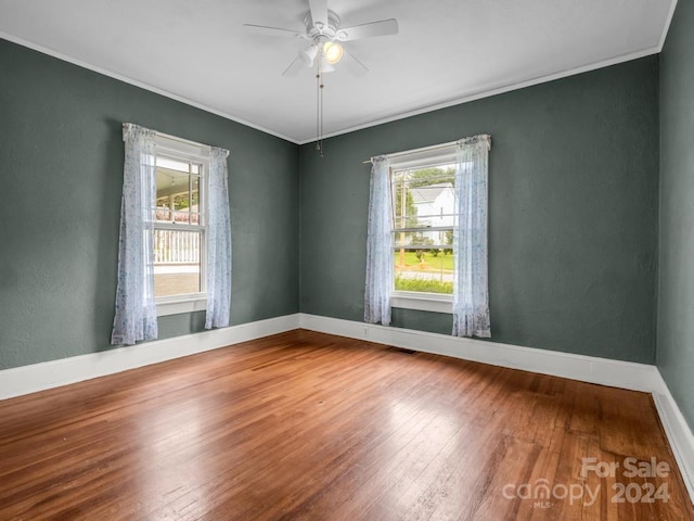 spare room featuring ceiling fan, crown molding, and hardwood / wood-style flooring