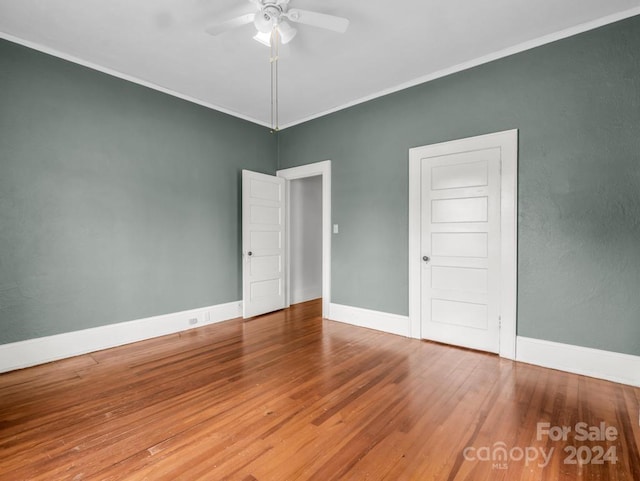 spare room featuring ceiling fan, ornamental molding, and hardwood / wood-style floors