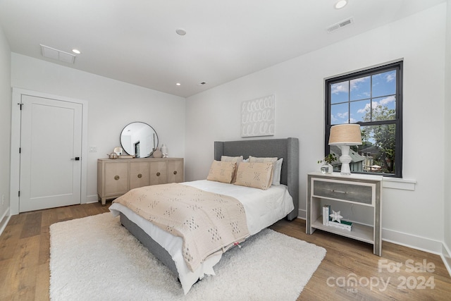 bedroom with hardwood / wood-style flooring