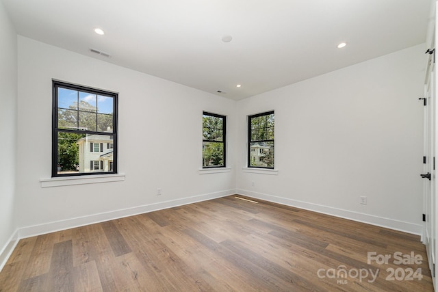 empty room with hardwood / wood-style floors