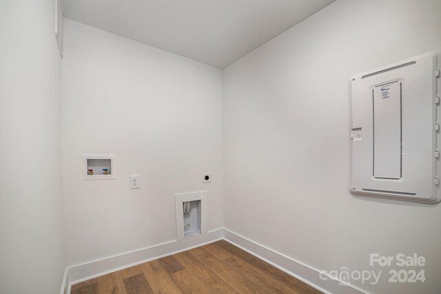 clothes washing area with hookup for an electric dryer, washer hookup, and hardwood / wood-style floors