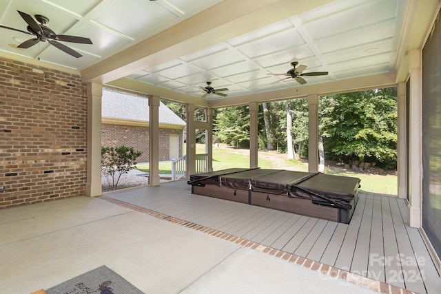 unfurnished sunroom featuring ceiling fan