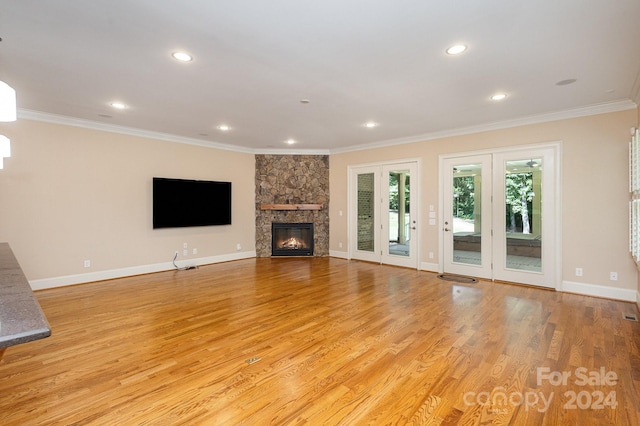 unfurnished living room featuring light wood-type flooring and crown molding