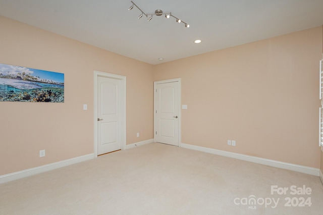 empty room featuring light colored carpet