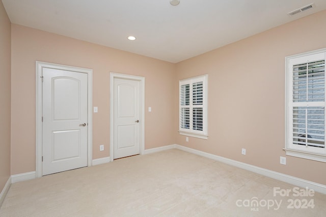 unfurnished bedroom with light carpet