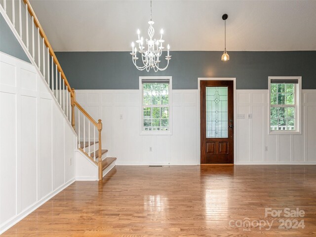 foyer with a chandelier and light hardwood / wood-style floors