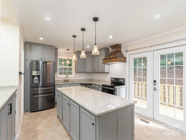 kitchen with backsplash, stainless steel appliances, light tile patterned floors, and custom range hood