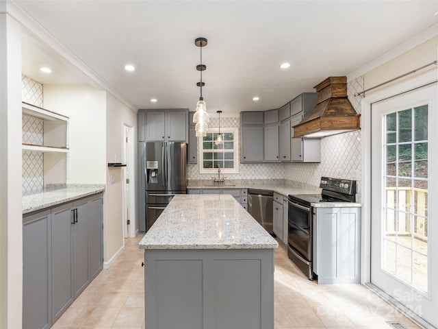 kitchen featuring light tile patterned flooring, stainless steel appliances, gray cabinetry, premium range hood, and decorative backsplash