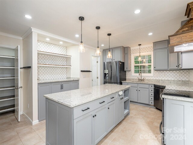 kitchen featuring tasteful backsplash, crown molding, pendant lighting, and stainless steel fridge