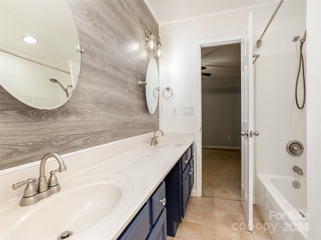 bathroom featuring dual vanity, bathtub / shower combination, wooden walls, and tile patterned flooring