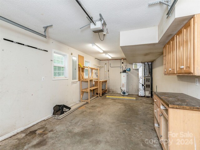 garage featuring electric panel, a garage door opener, water heater, and heating unit