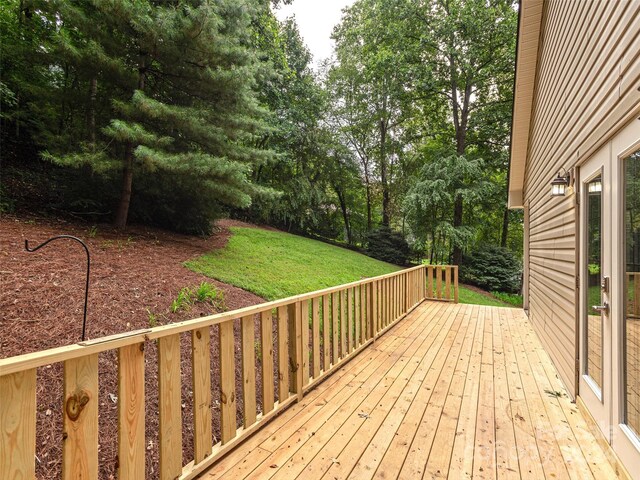 wooden terrace with a yard