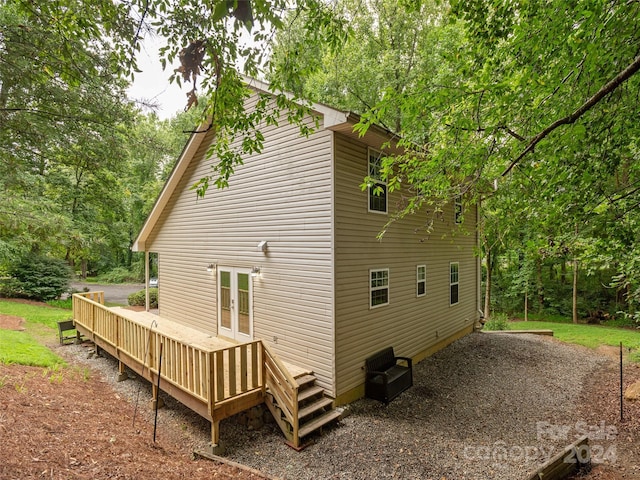 back of property featuring french doors and a deck