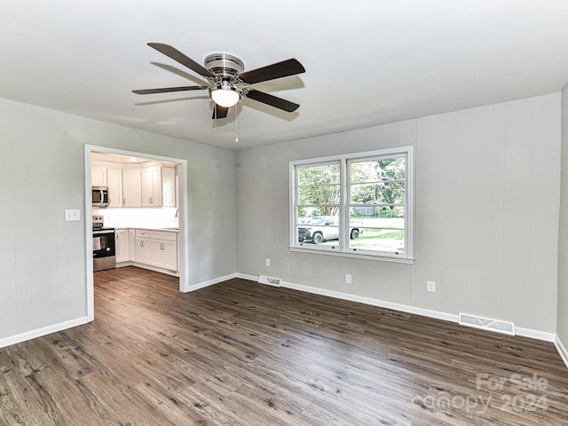 unfurnished living room with ceiling fan, wood-type flooring, and sink