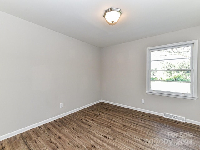 empty room featuring wood-type flooring