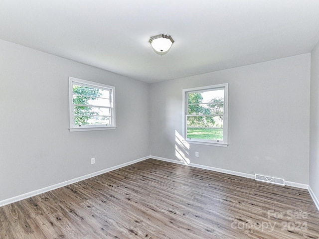 spare room with hardwood / wood-style flooring