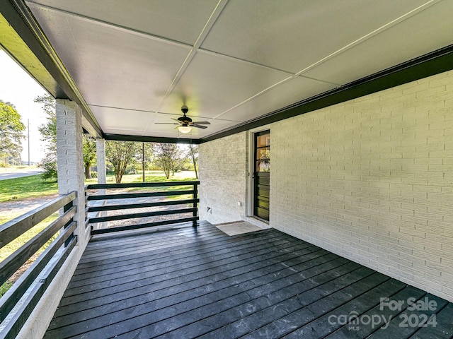 wooden deck featuring ceiling fan