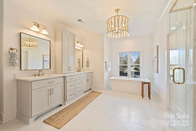 bathroom featuring separate shower and tub, vanity, and an inviting chandelier