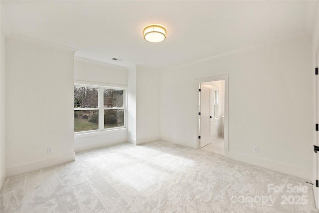 carpeted empty room featuring ornamental molding