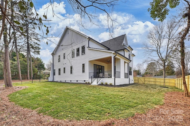 view of side of property featuring ceiling fan and a lawn