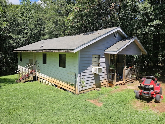 exterior space featuring cooling unit and a lawn