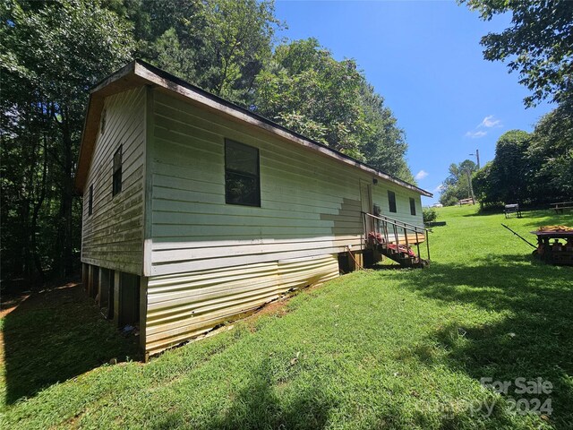 view of side of home featuring a lawn