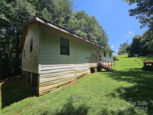 view of property exterior featuring a yard