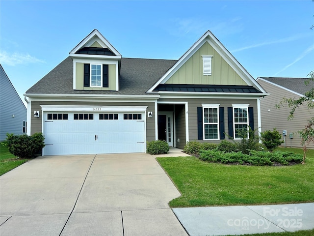 view of front of house with a front yard and a garage