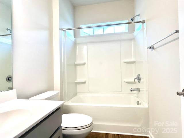 full bathroom featuring hardwood / wood-style flooring, vanity, toilet, and shower / bath combination