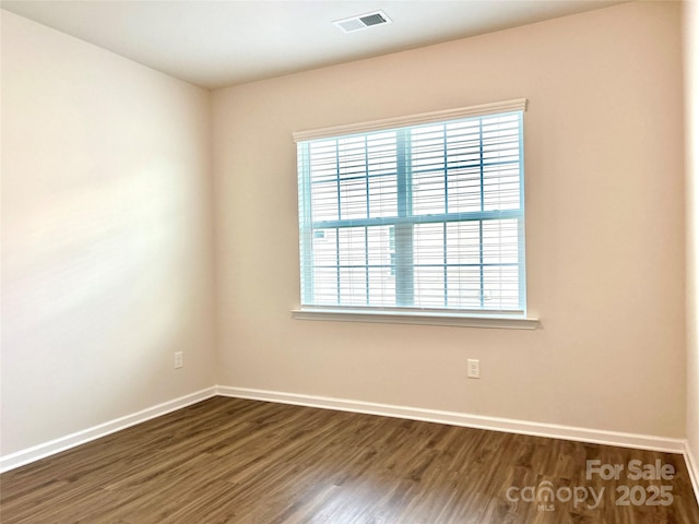 spare room with dark hardwood / wood-style floors