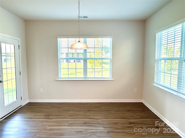 unfurnished dining area featuring dark hardwood / wood-style floors