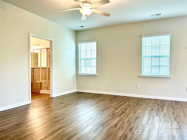 empty room featuring ceiling fan and dark wood-type flooring