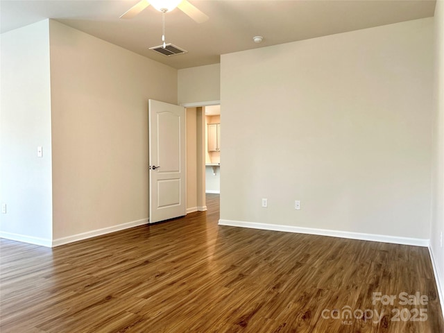 spare room featuring dark hardwood / wood-style floors and ceiling fan