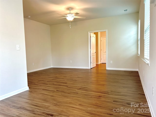 spare room with ceiling fan and dark hardwood / wood-style flooring